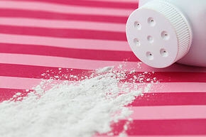 Talcum powder spills out of a bottle