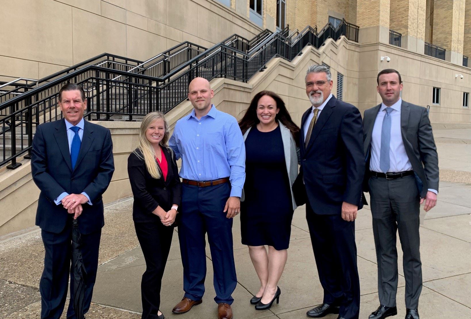 Attorney Stephen Cain with his clients, who won a settlement from the federal government.